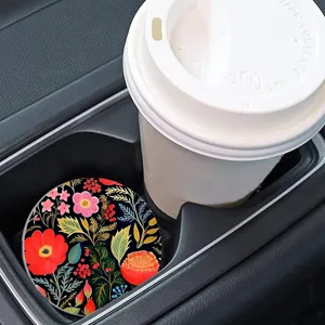 Car cup holder coaster detail showing vibrant floral botanical print in a vehicle interior.