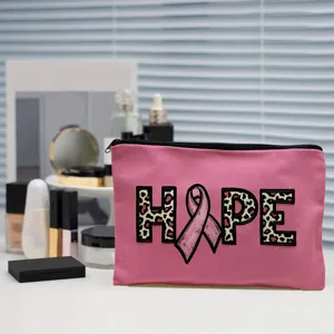 Pink canvas cosmetic bag with hope print and ribbon pattern for daily travel use.