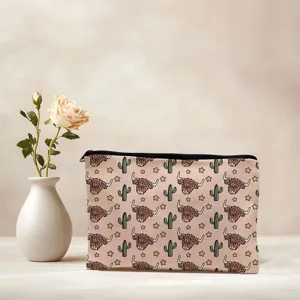 Detailed view of the cute highland cow print cosmetic bag, featuring durable canvas and zipper.