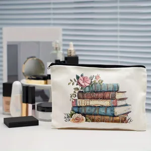 Vintage book and floral print canvas makeup pouch, detailed closeup of stylish cosmetic bag.