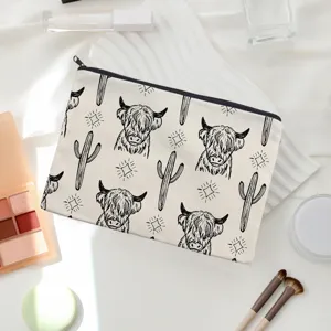 Canvas cosmetic pouch with cute highland cow and cactus print, ideal for travel and daily storage.