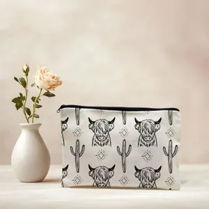Canvas makeup pouch detail, cute highland cow print zipper bag for daily cosmetics.