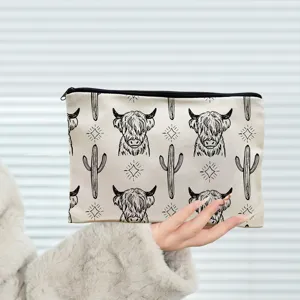 Canvas zipper pouch with cute highland cow and cactus print, multi-use cosmetic and pencil bag.
