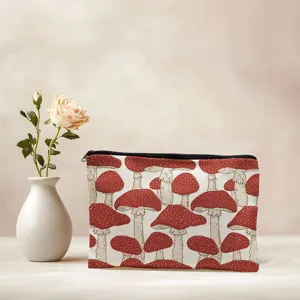 Canvas cosmetic bag with red mushroom print, portable travel makeup pouch for toiletries.