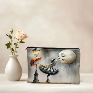 Canvas cosmetic bag detail showing artistic moon and girl print, portable storage pouch.