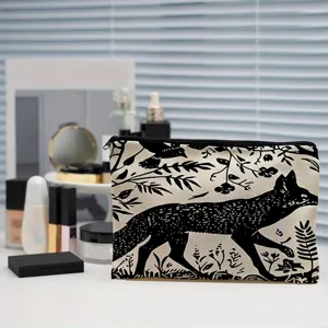 Canvas cosmetic bag with black fox print, travel toiletry pouch and pencil case detail.