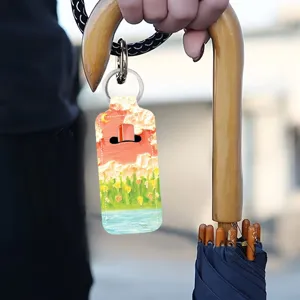 Close-up of oil painting style lipstick holder keychain, creative bag pendant accessory detail.