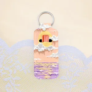 Detailed view of an oil painting style lipstick holder keychain, creative bag charm accessory.