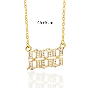 Close-up detail of the rhinestone encrusted angel number gold necklace pendant and link chain.