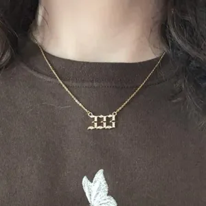 Close-up detail of elegant angel number 333 rhinestone pendant necklace for women