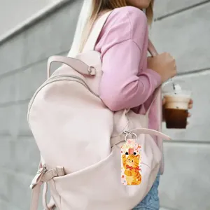 Closeup detail shot of cute cartoon cat neoprene lipstick holder keychain bag pendant accessory.