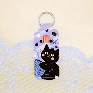 Detailed view of the cute black cat neoprene lipstick holder keychain, perfect bag accessory.