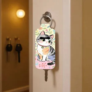 Close-up detail shot of the cute cat print neoprene key cover hanging neatly on wall.