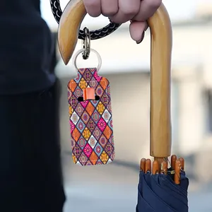 Neoprene lipstick holder keychain with boho geometric pattern, ideal bag charm accessory.