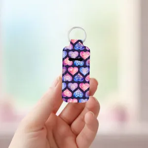 Neoprene lipstick holder keychain with colorful heart pattern close up detail view design.