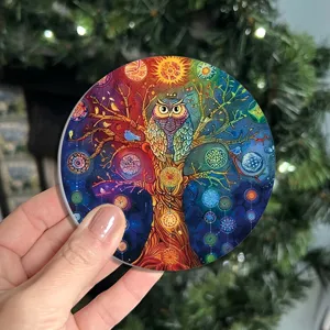Detailed view of a vibrant round cup coaster featuring a colorful tree of life and owl art.