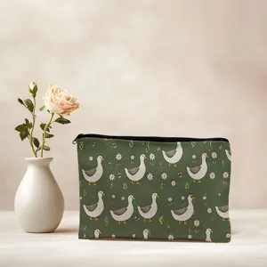 Cute duck print cosmetic bag, green canvas travel makeup pouch with zipper closure.