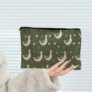 Green duck print cosmetic bag detail, cute animal pattern makeup pouch for travel.