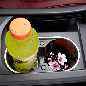 Car cup holder coaster detail view, showcasing the pink cherry blossom pattern design clearly.