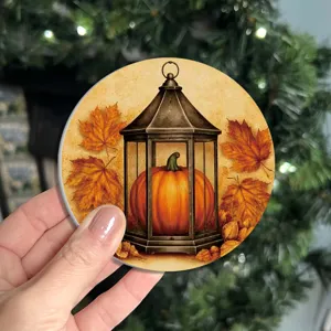Close-up detail view of the round autumn pumpkin lantern pattern silicone coaster.