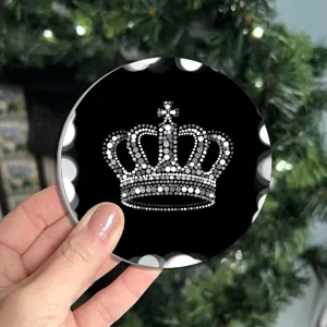 Round black drink coaster featuring a stylish white dot matrix crown pattern for table decor.