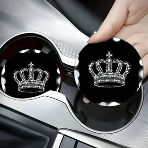 Close-up detail shot of sparkling rhinestone crown car cup coaster, black silicone accessory.
