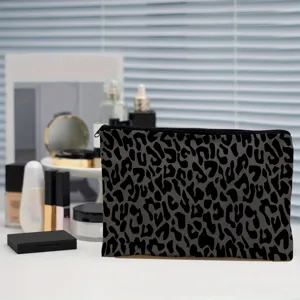 Black and grey leopard print cosmetic pouch, stylish portable makeup bag for women daily use.
