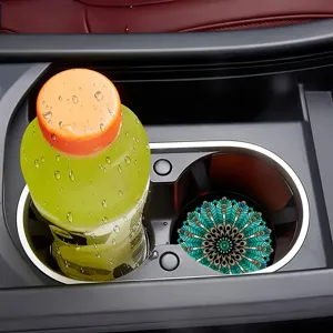 Close-up detail of a decorative mandala car cup coaster placed neatly in a vehicle console.