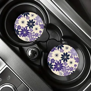 Detailed view of floral car coasters placed in a vehicle cup holder, stylish interior accessory.