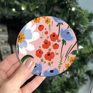 Detailed view of the round floral car cup coaster showing the vibrant pink flower pattern design.