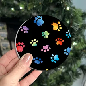 Detailed view of the colorful paw print car coaster, absorbent ceramic cup holder mat.