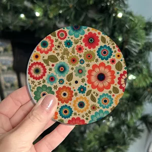 Round floral coffee coaster with retro colorful flower print for home kitchen table decor.