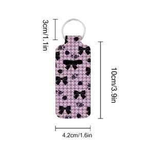 Detail view showing the dimensions of the neoprene lipstick holder keychain with bow print.