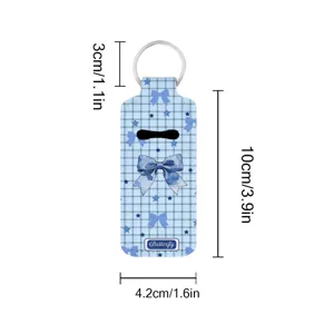 Neoprene lipstick holder keychain featuring blue plaid pattern and bow print, compact size.