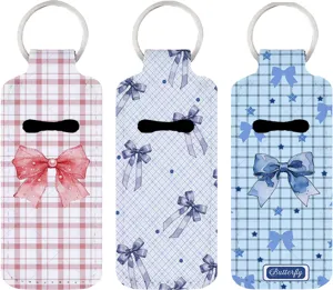 Neoprene lipstick holder keychain detail view, cute bow print pattern design for car keys.
