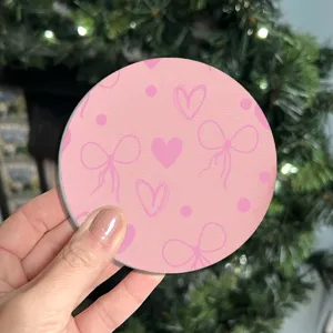 Round pink car cup coaster with cute bow and heart pattern, non-slip anti-scald thermal mat.