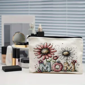 Close-up of white canvas cosmetic bag with watercolor floral MOM print and black zipper detail.