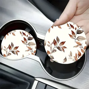 Detailed view of round car cup coaster with elegant brown watercolor autumn leaves pattern.