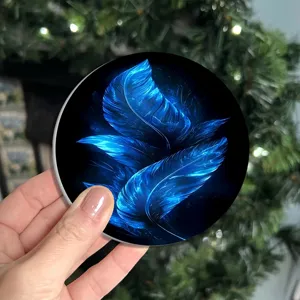 Close-up detail of the glowing blue feather car cup coaster, showing vivid print.
