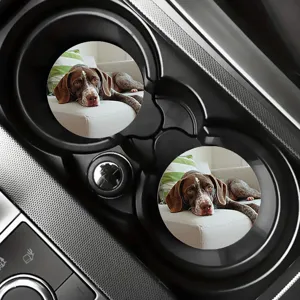 Detail view of cute dog pattern silicone car coasters placed in cup holder, non-slip design.