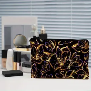Canvas cosmetic bag featuring a stunning black and gold glitter floral print design. Detail view.