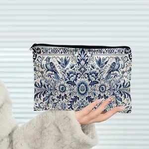 Blue and white floral canvas zipper pouch detail showcasing intricate traditional bird pattern.