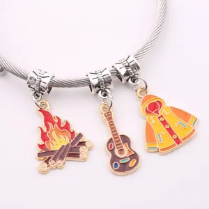 Detail shot of DIY enamel alloy bracelet featuring cute campfire, guitar and raincoat charms.