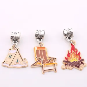 Detail view of alloy enamel camping charms featuring tent, beach chair and campfire designs.