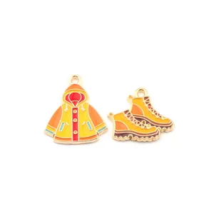 Close-up detail of cute DIY enamel alloy raincoat and boots charms for jewelry making.