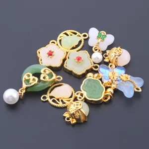 Detail shot of assorted alloy and jade DIY jewelry pendants, charms for bracelets and necklaces.