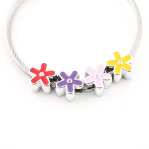 Detailed view of silver wire bracelet with colorful enamel flower beads DIY accessories.