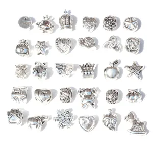 Close-up detail of silver alloy DIY large hole beads and spacer charms for handmade bracelets.