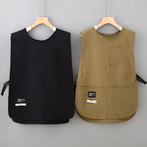 Detail view of Japanese style sleeveless work aprons in black and khaki with practical pockets.