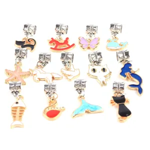 Close-up details of assorted alloy enamel DIY jewelry charms, cute animal and tail pendants.